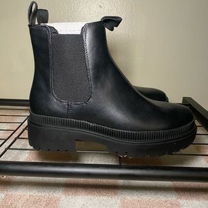 Women’s black leather Chelsea boots.